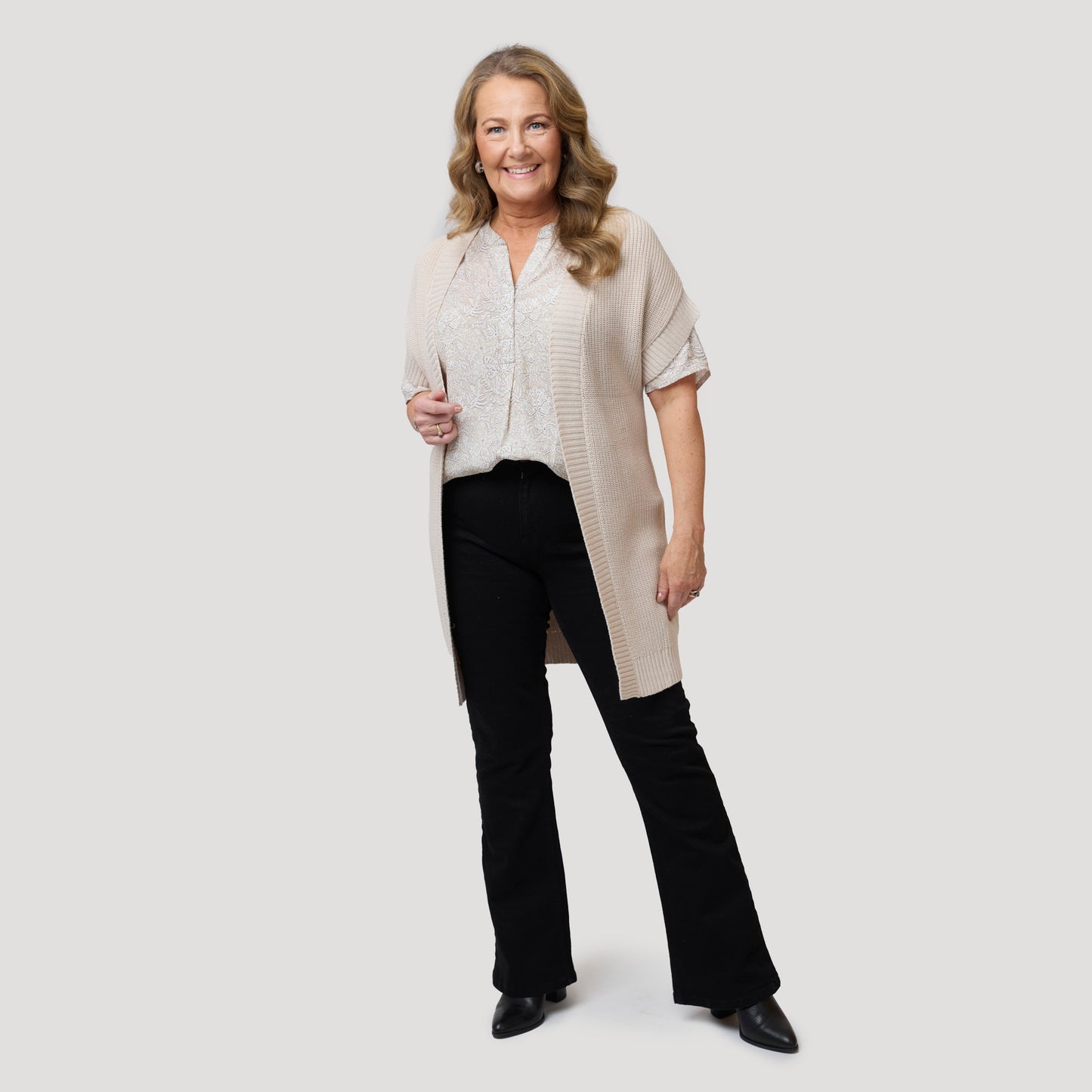 Beige-kuvioinen paita auki olevaan kardiganiin